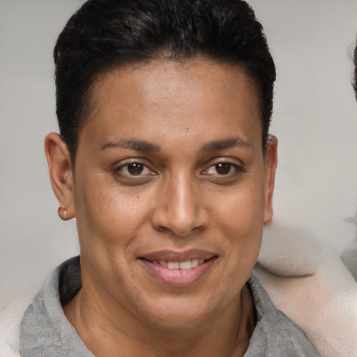 Joyful latino adult female with short  brown hair and brown eyes