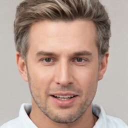 Joyful white adult male with short  brown hair and brown eyes