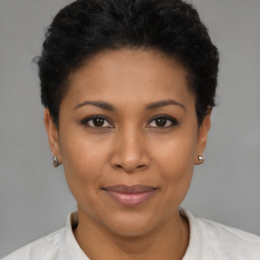 Joyful black young-adult female with short  brown hair and brown eyes