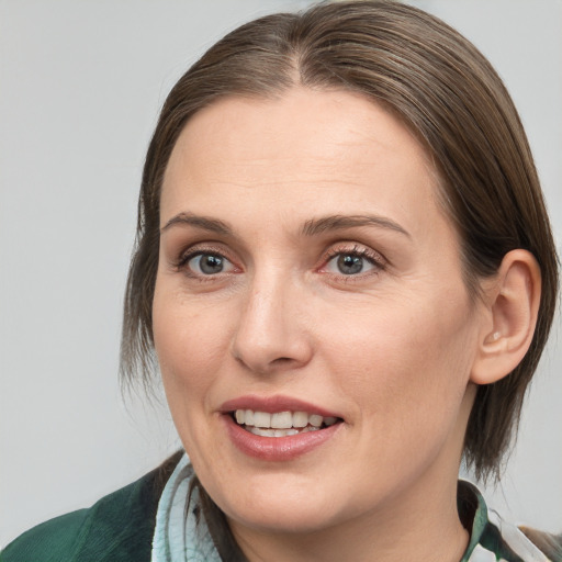 Joyful white adult female with medium  brown hair and brown eyes