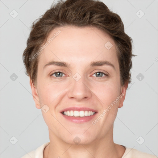 Joyful white young-adult female with short  brown hair and grey eyes