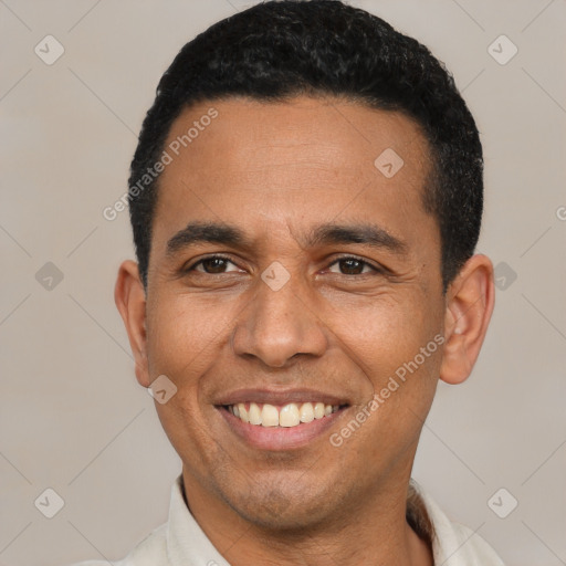 Joyful latino young-adult male with short  black hair and brown eyes