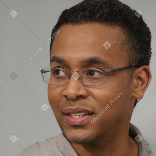 Joyful black young-adult male with short  black hair and brown eyes