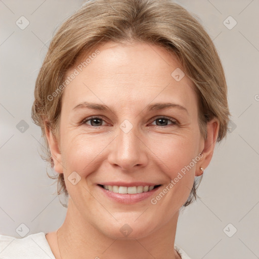 Joyful white adult female with medium  brown hair and grey eyes