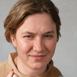 Joyful white adult female with medium  brown hair and grey eyes