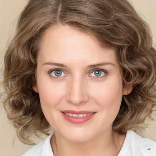 Joyful white young-adult female with medium  brown hair and green eyes