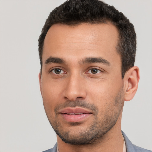 Joyful white young-adult male with short  black hair and brown eyes