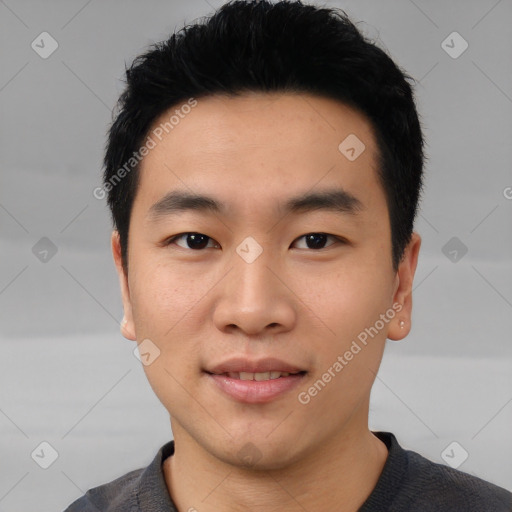 Joyful asian young-adult male with short  black hair and brown eyes