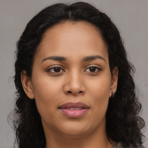 Joyful latino young-adult female with long  brown hair and brown eyes