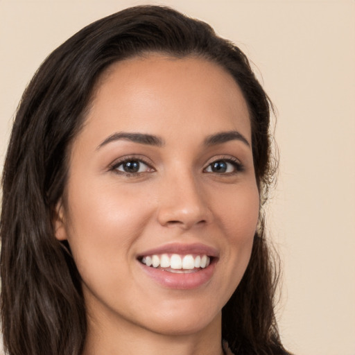 Joyful white young-adult female with long  brown hair and brown eyes