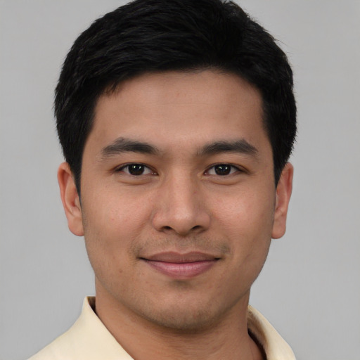 Joyful white young-adult male with short  black hair and brown eyes