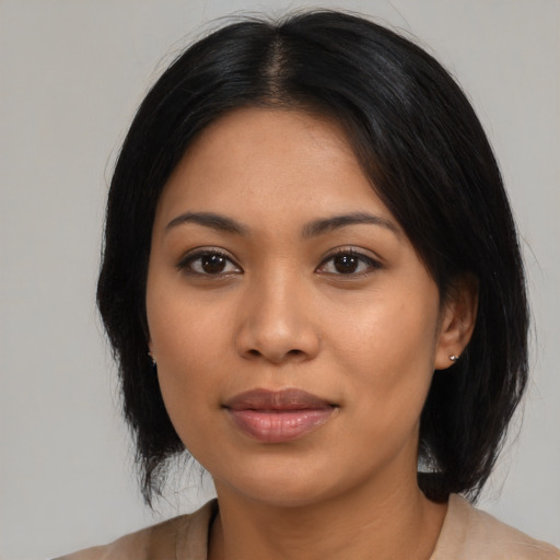 Joyful latino young-adult female with medium  black hair and brown eyes