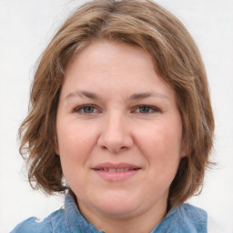 Joyful white young-adult female with medium  brown hair and blue eyes