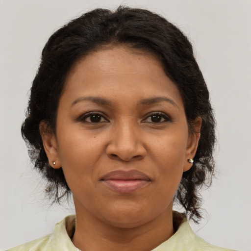 Joyful black adult female with medium  brown hair and brown eyes