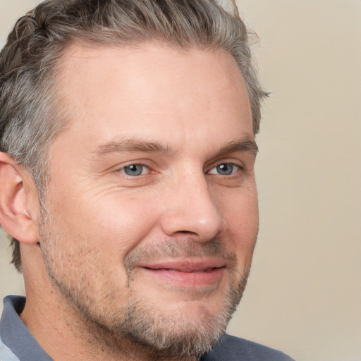 Joyful white adult male with short  brown hair and grey eyes