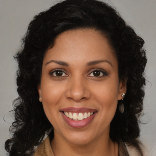 Joyful latino young-adult female with long  brown hair and brown eyes