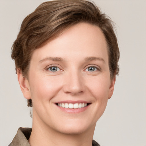 Joyful white young-adult female with short  brown hair and grey eyes