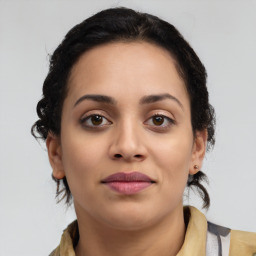 Joyful latino young-adult female with medium  brown hair and brown eyes