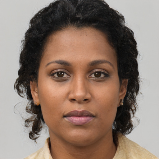 Neutral black young-adult female with medium  brown hair and brown eyes