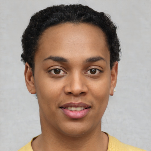 Joyful latino young-adult female with short  black hair and brown eyes