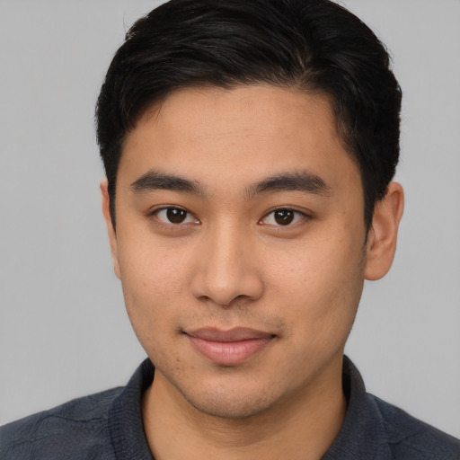 Joyful asian young-adult male with short  brown hair and brown eyes