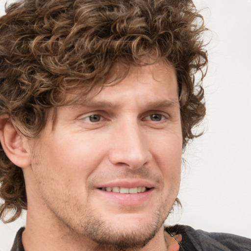 Joyful white adult male with short  brown hair and grey eyes