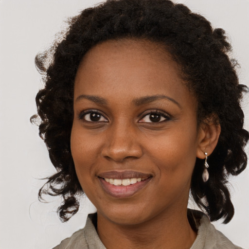 Joyful black young-adult female with medium  brown hair and brown eyes