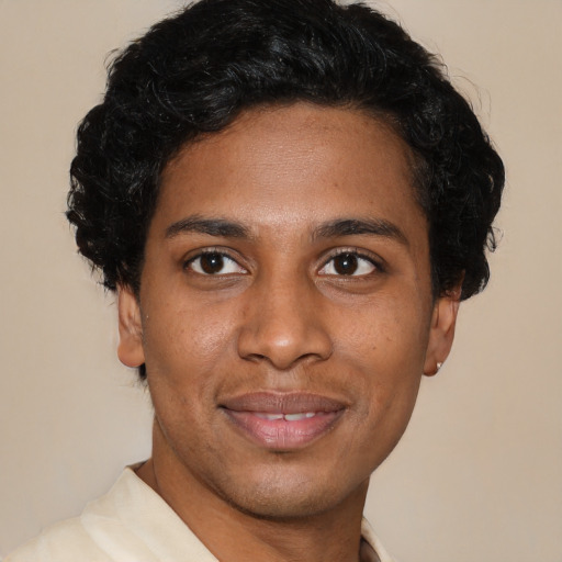 Joyful latino young-adult male with short  brown hair and brown eyes