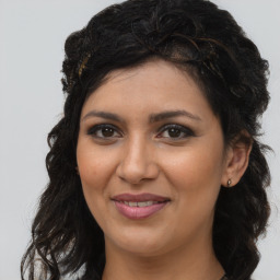 Joyful latino young-adult female with long  brown hair and brown eyes