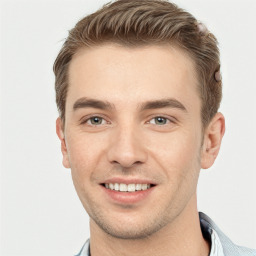 Joyful white young-adult male with short  brown hair and grey eyes