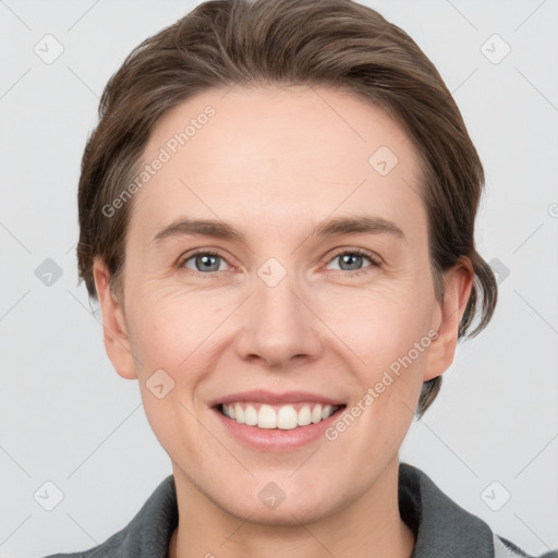 Joyful white young-adult female with medium  brown hair and grey eyes