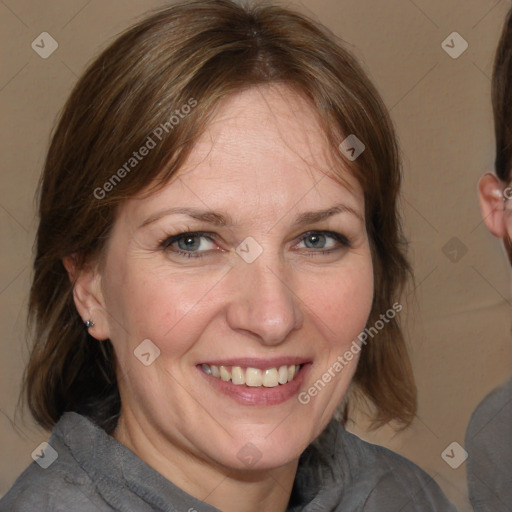 Joyful white adult female with medium  brown hair and grey eyes