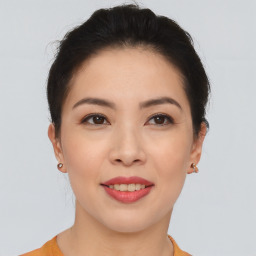 Joyful asian young-adult female with short  brown hair and brown eyes