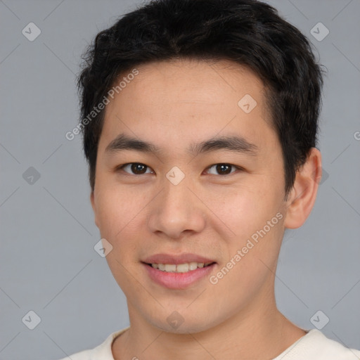 Joyful asian young-adult male with short  brown hair and brown eyes