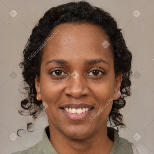 Joyful black adult female with medium  brown hair and brown eyes