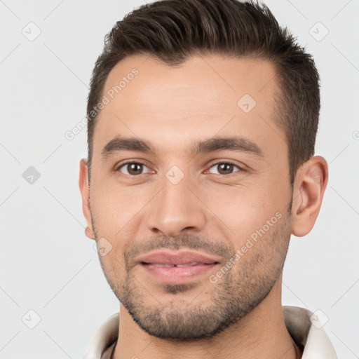 Joyful white young-adult male with short  brown hair and brown eyes