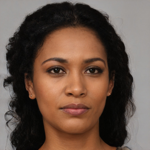 Neutral black young-adult female with long  brown hair and brown eyes