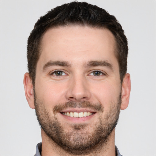 Joyful white young-adult male with short  brown hair and brown eyes