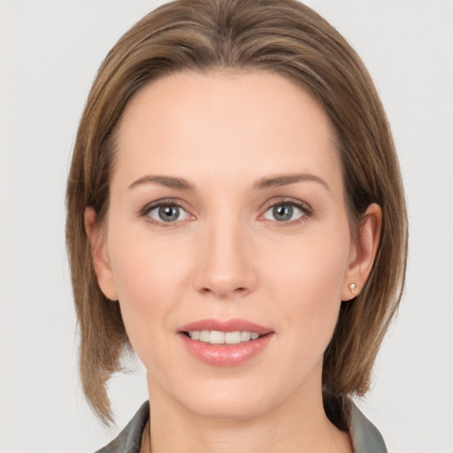 Joyful white young-adult female with medium  brown hair and grey eyes