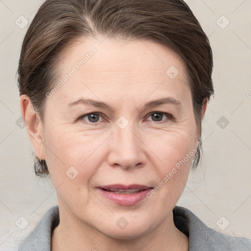 Joyful white adult female with medium  brown hair and brown eyes