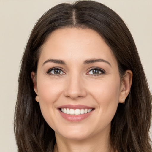 Joyful white young-adult female with long  brown hair and brown eyes