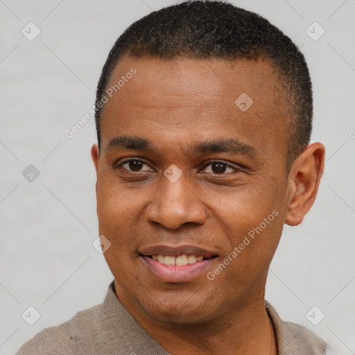 Joyful black young-adult male with short  black hair and brown eyes