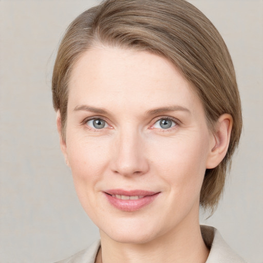 Joyful white young-adult female with medium  brown hair and blue eyes