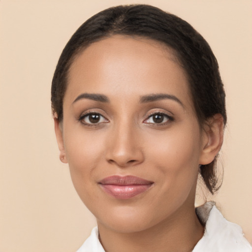 Joyful latino young-adult female with medium  brown hair and brown eyes