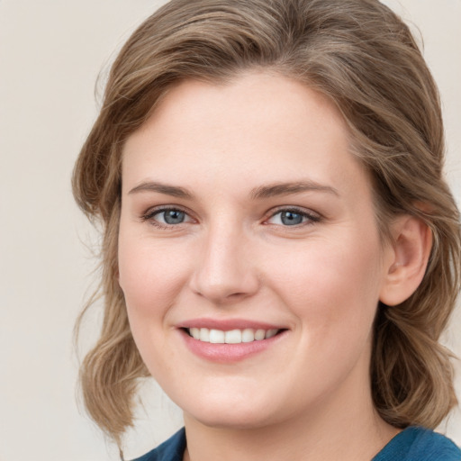 Joyful white young-adult female with medium  brown hair and blue eyes