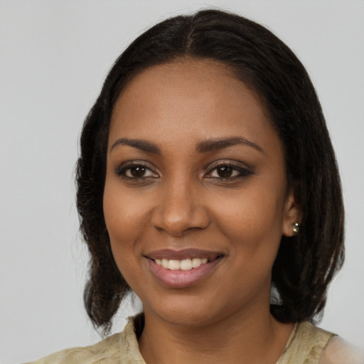 Joyful black young-adult female with medium  brown hair and brown eyes