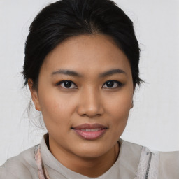 Joyful asian young-adult female with medium  black hair and brown eyes