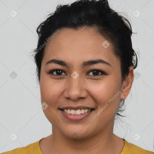 Joyful latino young-adult female with short  brown hair and brown eyes