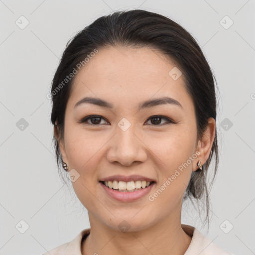 Joyful asian young-adult female with medium  brown hair and brown eyes