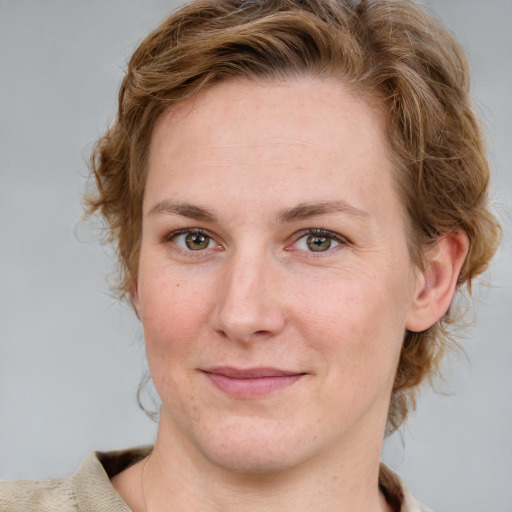 Joyful white young-adult female with medium  brown hair and blue eyes